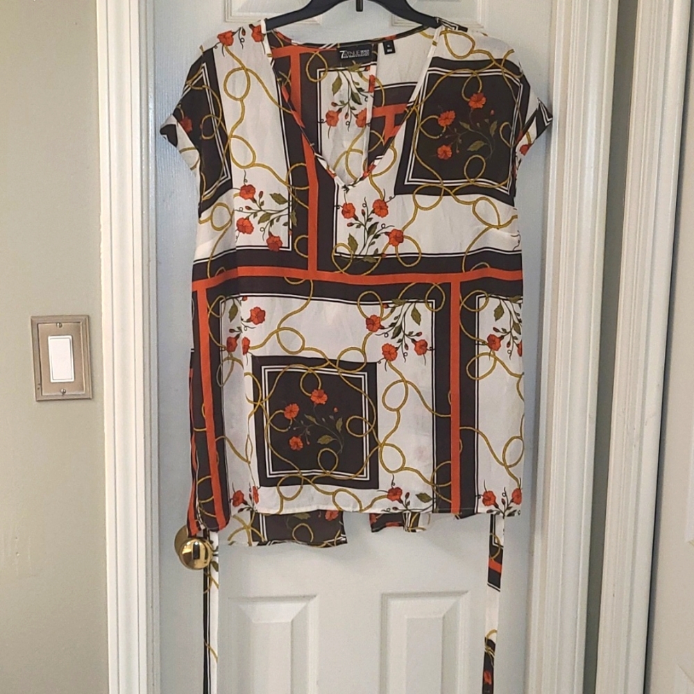 White, brown and orange top that ties in the back.